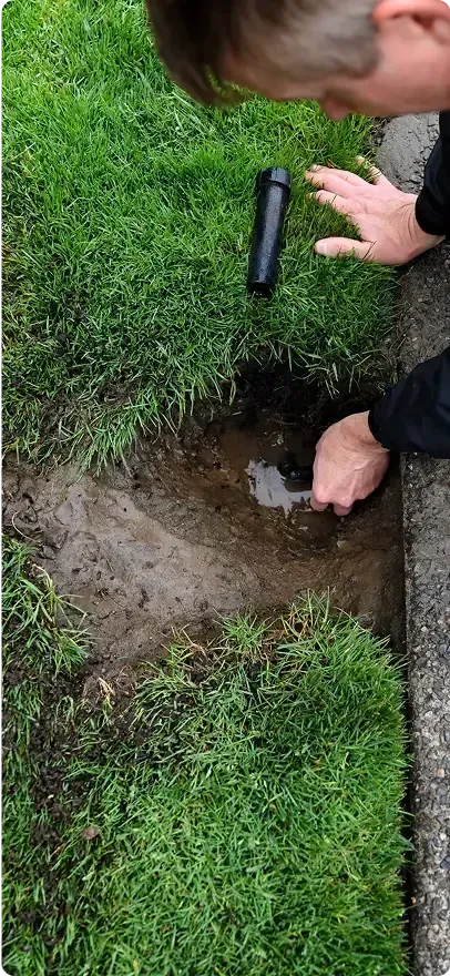 Close-up of an irrigation repair expert doing work on an irrigation system.
