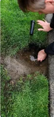 Close-up of an irrigation repair expert doing work on an irrigation system.